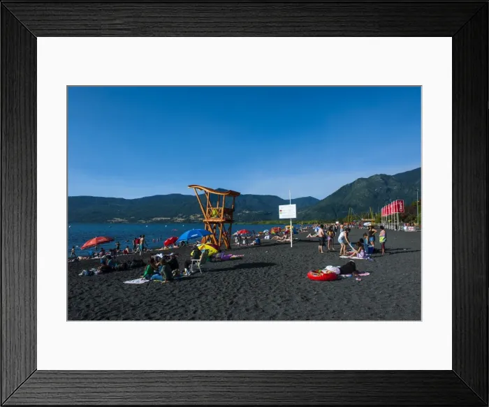 Framed Print : Tourists sunbathing on the volcanic sand beach on Lago Villarrica, Pucon, Chile, South America Framed Print : Tourists sunbathing on the volcanic sand beach on Lago Villarrica, Pucon, Chile, South America