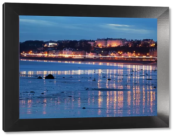 Seafront illuminations reflected on wet sands, Filey, North Yorkshire, England, United Kingdom, Europe