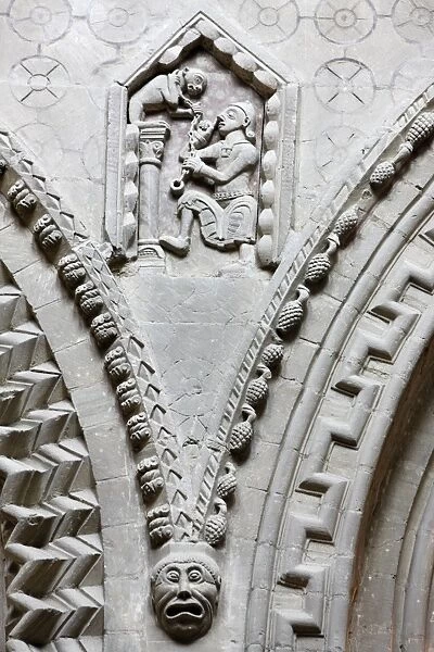 A 12th century corner stone depicting a man performing with a monkey, Notre Dame de Bayeux cathedral, Bayeux, Normandy