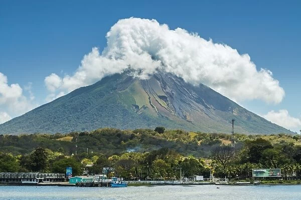The 1610m Volcan Concepcion looms behind port of Moyogalpa in west of the island, Moyogalpa, Isla Omotepe, Lake Nicaragua, Nicaragua, Central America