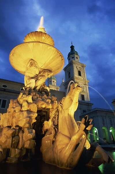 The 17th century fountain in the Residenzplatz illuminated by night, Salzburg