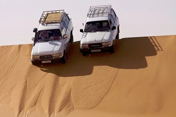 Two 4X4s on the dunes of the erg of Murzuk in the Fezzan Desert, Libya