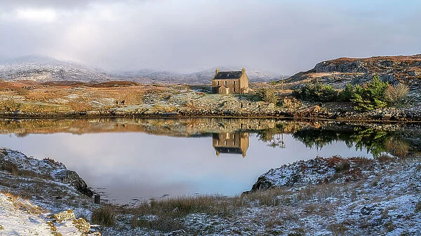 Abandoned house reflected in the loch on a winter's day, Isle of Harris, Outer Hebrides, Scotland, United Kingdom, Europe