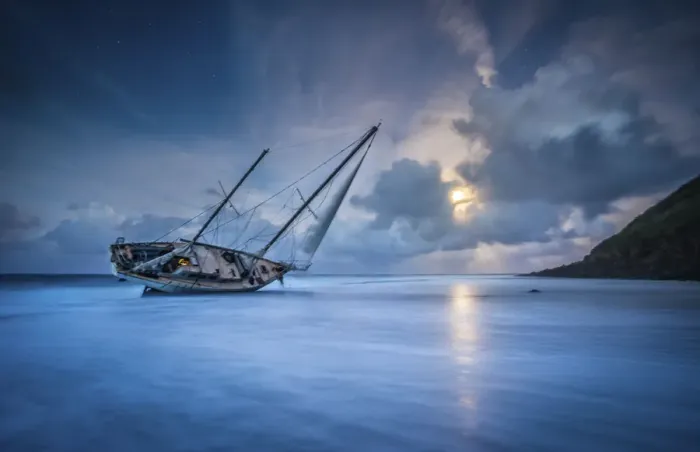 Framed Print : An abandoned sailboat rests on its side at low tide in Moloa a Bay Framed Print : An abandoned sailboat rests on its side at low tide in Moloa a Bay