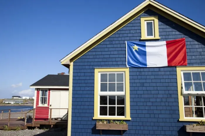 Framed Print : Acadian flag on blue house in La Grave, Ile Havre-Aubert, one of the Iles de la Madeleine Framed Print : Acadian flag on blue house in La Grave, Ile Havre-Aubert, one of the Iles de la Madeleine