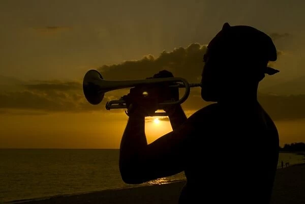 Actor playing the trumpet at sunset, Trinidad, Cuba, West Indies, Central America