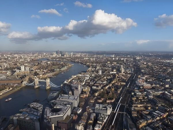 Aerial cityscape showing River Thames, Tower Bridge and railway tracks, London, England, United Kingdom, Europe