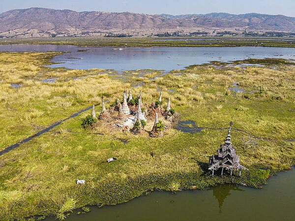 Aerial by drone of little pagodas sitting in the waters of the southern Inle Lake