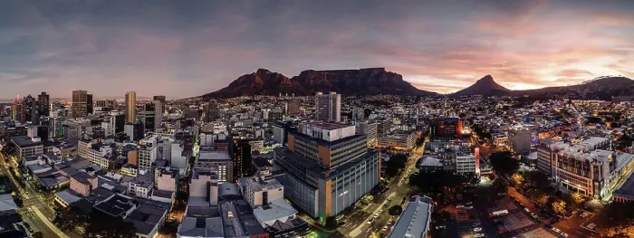Framed Print : Aerial drone panoramic view of the cityscape as dusk sets in, highlighting the downtown buildings with a warm glow against the silhouette of Table Mountain and Lion's Head, Cape Town, Western Cape, South Africa, Africa Framed Print : Aerial drone panoramic view of the cityscape as dusk sets in, highlighting the downtown buildings with a warm glow against the silhouette of Table Mountain and Lion's Head, Cape Town, Western Cape, South Africa, Africa