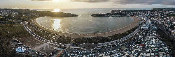 Aerial drone panoramic view at sunset of Sao Martinho do Porto bay, shaped like a scallop with calm waters and fine white sand, Oeste, Portugal, Europe