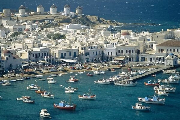 Aerial of the harbour and Mykonos town with windmills