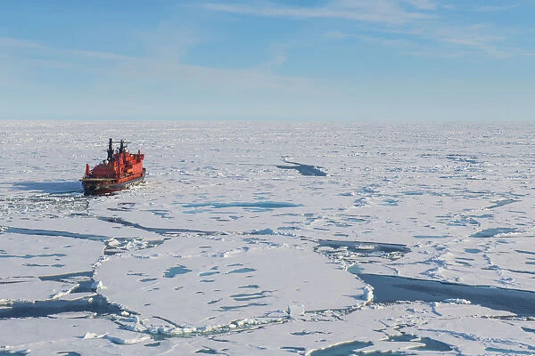 Aerial of the Icebreaker 50 years of victory on the North Pole through the window of a helicopter