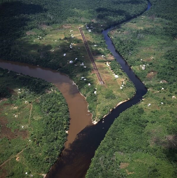 Aerial image of Kamarang Mouth Station and airstrip at the confluence of the unpolluted Kamarang River with the mined and heavily polluted Upper Mazaruni River in March 2005, Guyana