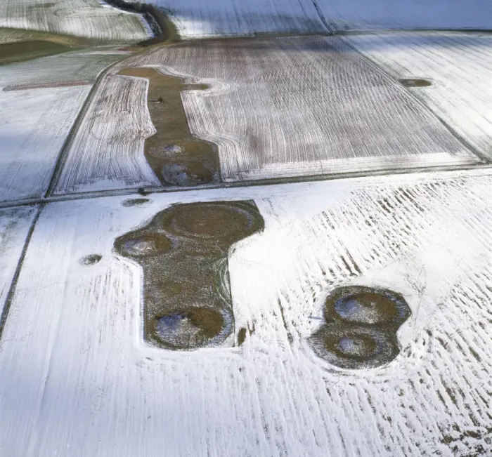 Framed Print : Aerial image of Normanton Down Barrows in snow, consisting of a Neolithic long barrow