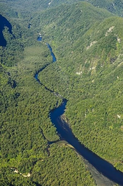 Aerial of a little river flowing through the untouched mountains of Fiordland National Park, UNESCO World Heritage Site, South Island, New Zealand, Pacific