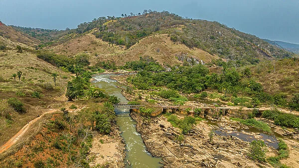 Aerial of an old railway bridge over the Cuvo River (Rio Keve), near confluence with Toeota River, Six Arches Bridge, Conda, Kumbira Forest Reserve, Kwanza Sul, Angola, Africa