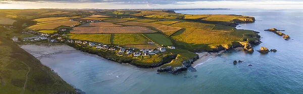 Aerial panorama of Porthcothan Bay and rugged Cornish coastline at dawn, Cornwall