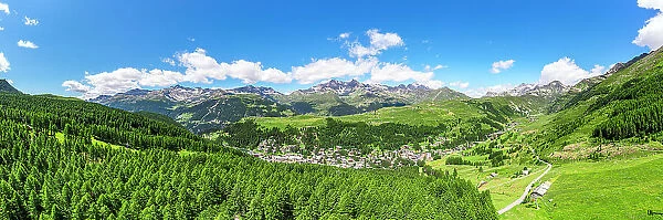 Aerial panoramic of the alpine village of Madesimo surrounded by green woods, Valle Spluga, Valtellina, Lombardy, Italy, Europe