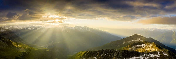 Aerial panoramic of Bernina mountain range and Pizzo Scalino lit by sunrise, Valmalenco