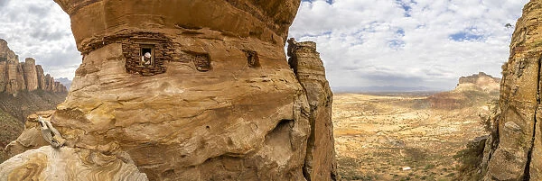 Aerial panoramic by drone of priest looking out from Abuna Yemata Guh rock-hewn church