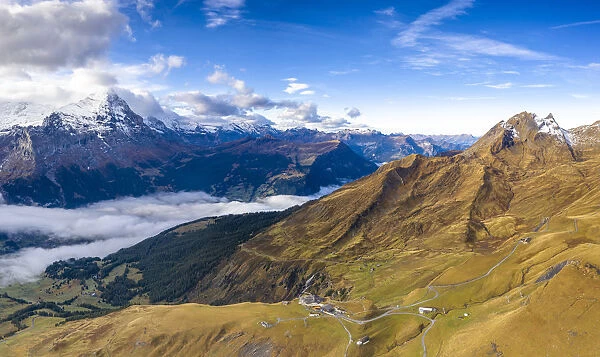 Aerial panoramic of Eiger and sea of clouds surrounding First and Grindelwald in autumn
