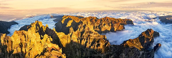 Aerial panoramic of Pico das Torres and Pico do Arieiro mountains in a sea of clouds at