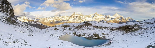 Aerial panoramic of Riffelsee lake surrounded by snow, Zermatt, canton of Valais