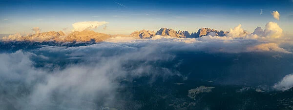 Aerial panoramic view of Brenta Dolomites emerging from clouds, Madonna di Campiglio