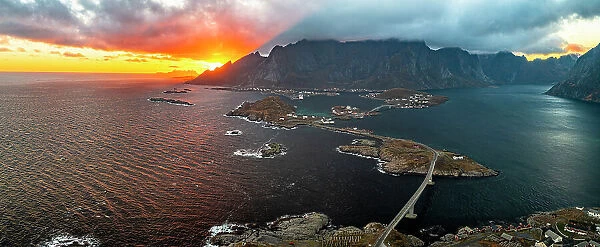Aerial panoramic view of Reine Bay and fjord under a fiery sky at sunset, Lofoten Islands, Nordland, Norway, Scandinavia, Europe