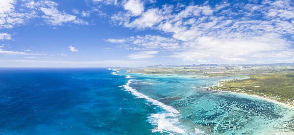 Aerial panoramic of waves of Indian Ocean and turquoise coral reef, Poste Lafayette