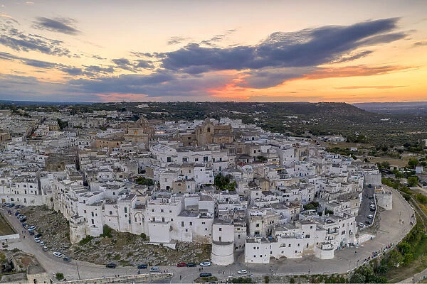 Aerial panoramic of white buildings in the old town of Ostuni at sunset