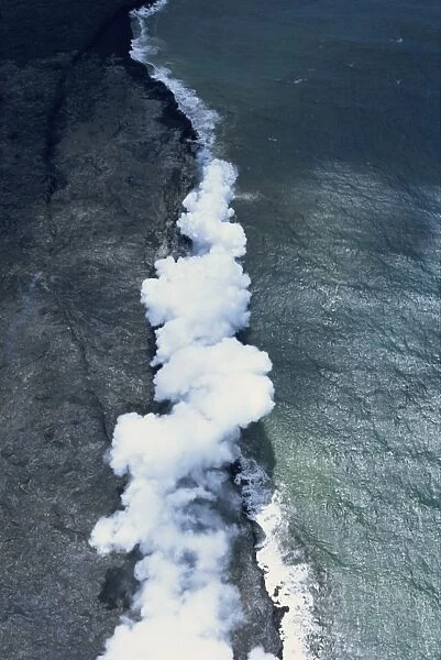Aerial view of basalt lava field with collapsed roof window into an active flowing lava tube on the south flank of Kilauea volcano in Puna, Big Island, Hawaii, Hawaiian Islands, United States of America, Pacific