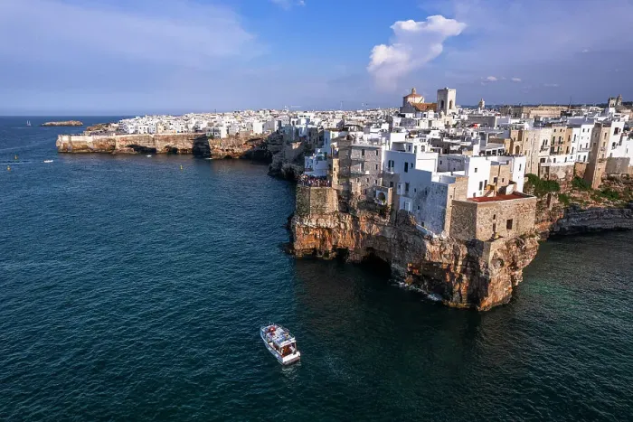 Framed Print : Aerial view of a boat sailing off the coast of Polignano a Mare fishing village, Bari, Apulia, Adriatic Sea, Mediterranean Sea, Italy, Europe Framed Print : Aerial view of a boat sailing off the coast of Polignano a Mare fishing village, Bari, Apulia, Adriatic Sea, Mediterranean Sea, Italy, Europe