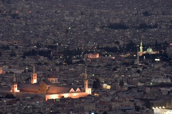Aerial view of city at night including the Umayyad Mosque