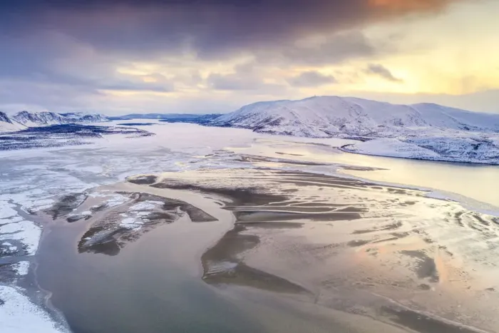 Framed Print : Aerial view of cold sea framed by snow capped mountains at sunset Framed Print : Aerial view of cold sea framed by snow capped mountains at sunset