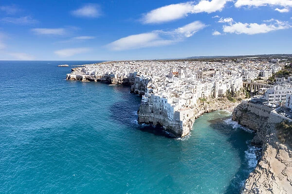 Aerial view of crystal sea surrounding Polignano a Mare on cliffs, province of Bari