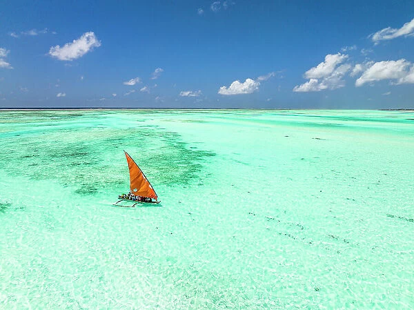 Aerial view of a dhow sailing in the transparent lagoon, Paje, Jambiani, Zanzibar, Tanzania, East Africa, Africa
