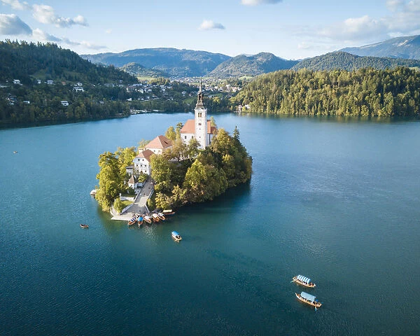 Aerial view by drone of Bled Island with the Church of the Assumption at dawn, Lake Bled