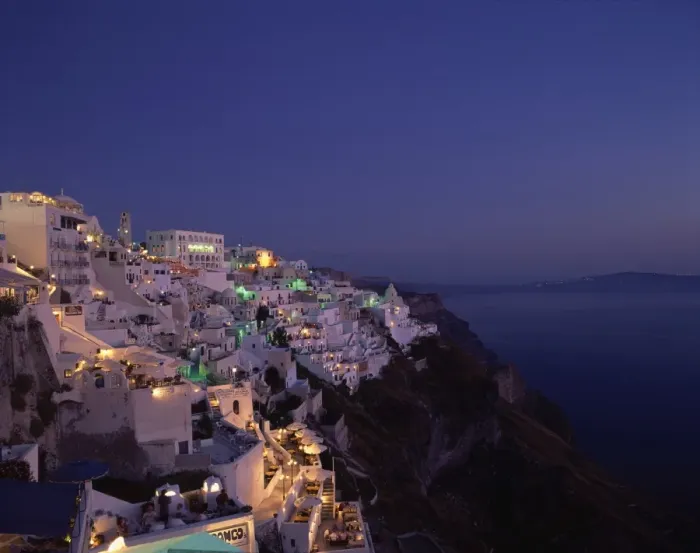 Framed Print : Aerial view over the illuminated houses of Fira Town at dusk Framed Print : Aerial view over the illuminated houses of Fira Town at dusk
