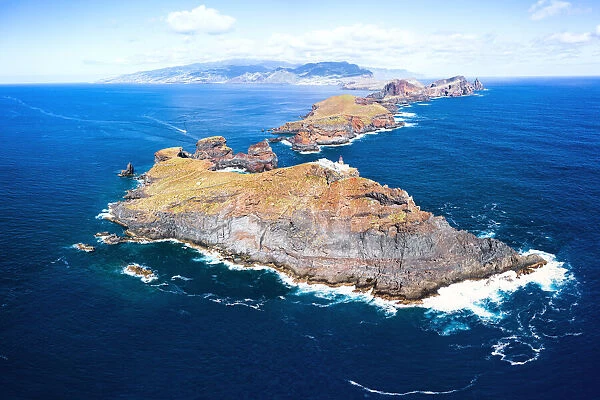 Aerial view of lighthouse on cliffs in the blue Atlantic Ocean, Sao Lourenco Peninsula