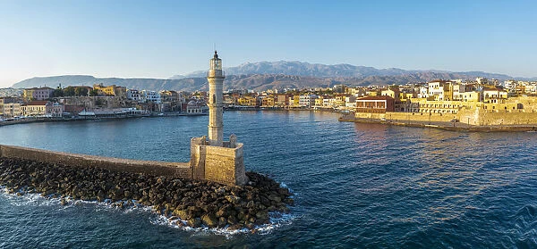 Aerial view of lighthouse and harbour of Chania old town at sunrise, island of Crete