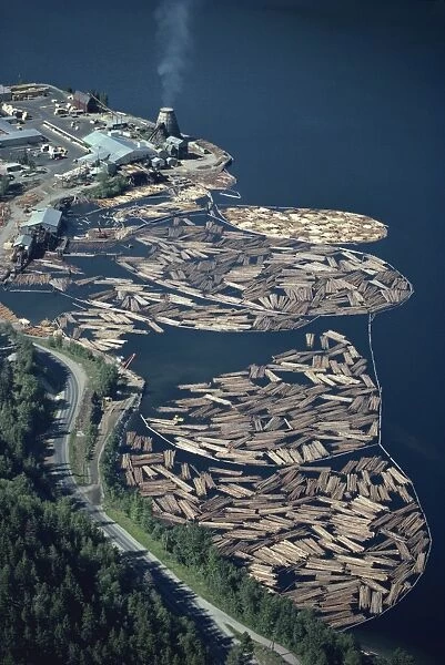 Aerial view of logs in the river beside a saw mill in British Columbia