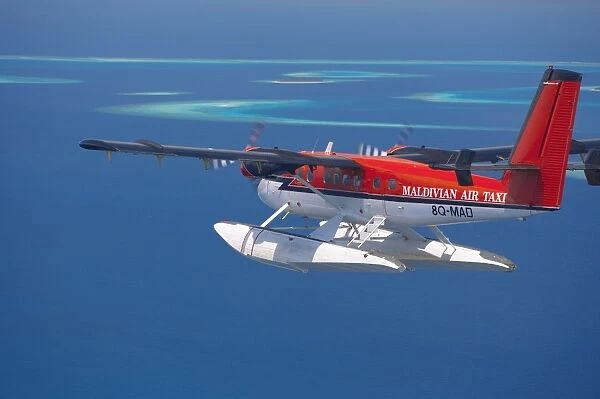 Aerial view of Maldivian air taxi flying in the Maldives archipelago, Indian Ocean, Asia