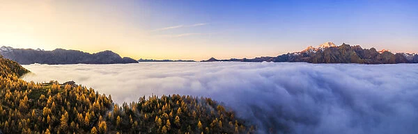 Aerial view of Malenco valley covered by fog at sunrise, Valmalenco, Valtelllina
