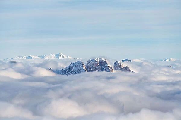 Aerial view of Monte Cristallo and Pomagagnon peaks emerging from clouds, Dolomites