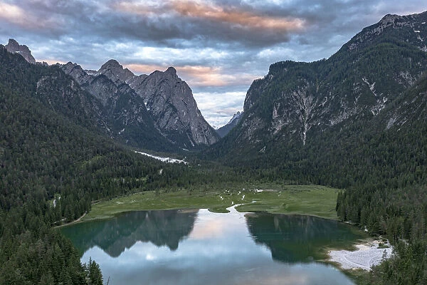 Aerial view of mountains reflected in lake Dobbiaco at sunset, Dobbiaco (Toblach)