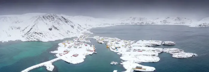 Framed Print : Aerial view of mountains and sea surrounding Sorvaer after a snow blizzard, Soroya Island Framed Print : Aerial view of mountains and sea surrounding Sorvaer after a snow blizzard, Soroya Island