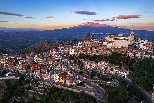 Aerial view of the old village of Centuripe with Mount Etna volcano Etna covered with snow and lit from the sunset, Centuripe, Enna province, Sicily, Italy, Mediterranean, Europe
