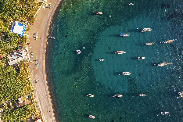 Aerial view of Palmarola bay with boats anchored in turquoise water at susnet, Palmarola island, Ponza municipality, Tyrrhenian sea, Pontine archipelago, Latina Province, Latium (Lazio), Italy, Europe