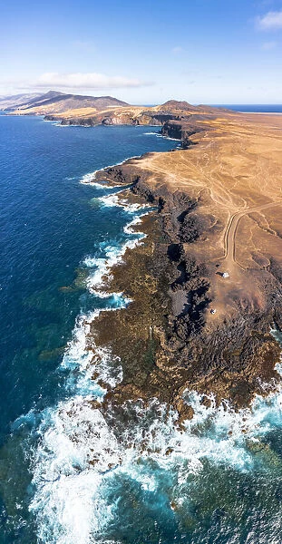 Aerial view of Punta Pesebre and Rabo de Raton volcanic cliffs washed by waves, Jandia